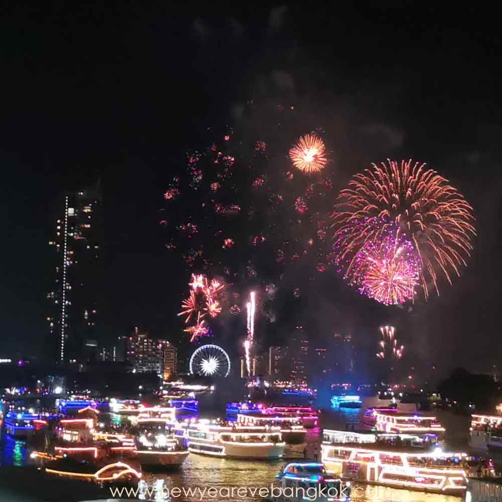 Best locations for viewing NYE fireworks along the river in Bangkok. Top Free Outdoor Places for Celebrating the Countdown Riverfront Promenade at ICONSIAM: While the shopping complex itself might be bustling, the public riverfront promenade is one of the best locations for viewing NYE fireworks. Get there early to secure your spot. The atmosphere is electric, with live music and a massive crowd all waiting for the countdown. It's the epicentre of the main fireworks event, guaranteeing an unparalleled view. Asiatique The Riverfront: This popular night market is a fantastic, family-friendly option. Located on the opposite bank of the river, Asiatique offers a great vantage point for the firework displays. The area is lively with a huge Ferris wheel, street food stalls, and entertainment. While some restaurants require reservations, the public walkways and open spaces are free to access, making it a prime spot to celebrate NYE. Public Piers and Parks Along the River: Several public areas along the Chao Phraya River offer excellent, unobstructed views. Consider scouting locations near Saphan Taksin BTS station or other smaller public piers. These spots are often less crowded than the main event areas but still provide a great view of the fireworks. Just be mindful of crowd control and traffic on the night itself. Taksin Bridge (Asiatiqe Riverfront side) New Year EVE Firework from Asiatiqe side. Describe Asiatique as a vibrant, free-to-enter area with a different kind of energy (carnival-like atmosphere). Mention the free firework show here and the general festive vibe. Taksin Bridge (IconSiam side) NYE firework from The IconSiam Side of Taksin Bridge Describe the advantages of this side. Proximity to the main fireworks display. Mention the view is straight-on.Advise readers to arrive early to secure a good spot see to location map : Taksin Bridge